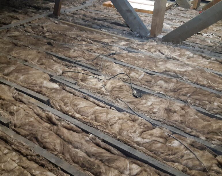 11 installation of 100mm base layer loft insulation